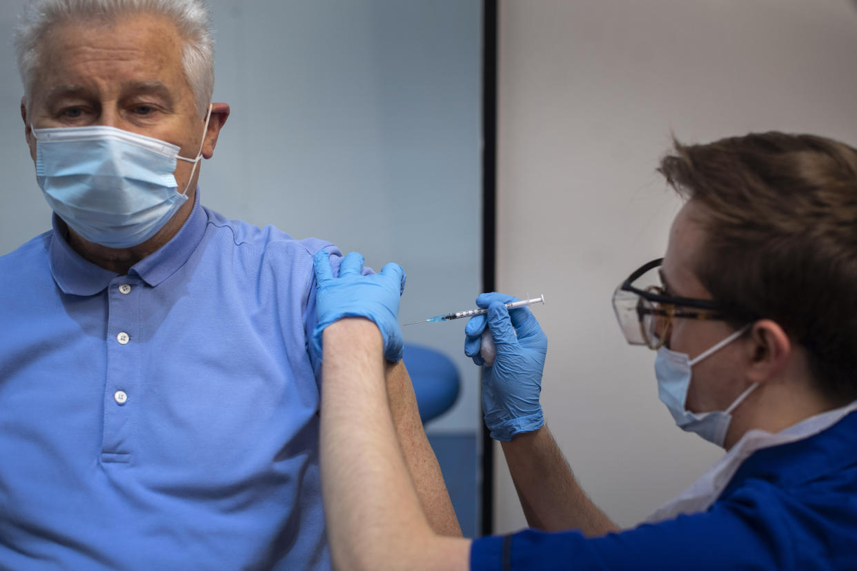 A man receives the first of two Pfizer/BioNTech Covid-19 vaccine jabs, at Guy's Hospital in London, on the first day of the largest immunisation programme in the UK's history. Care home workers, NHS staff and people aged 80 and over began receiving the jab this morning.