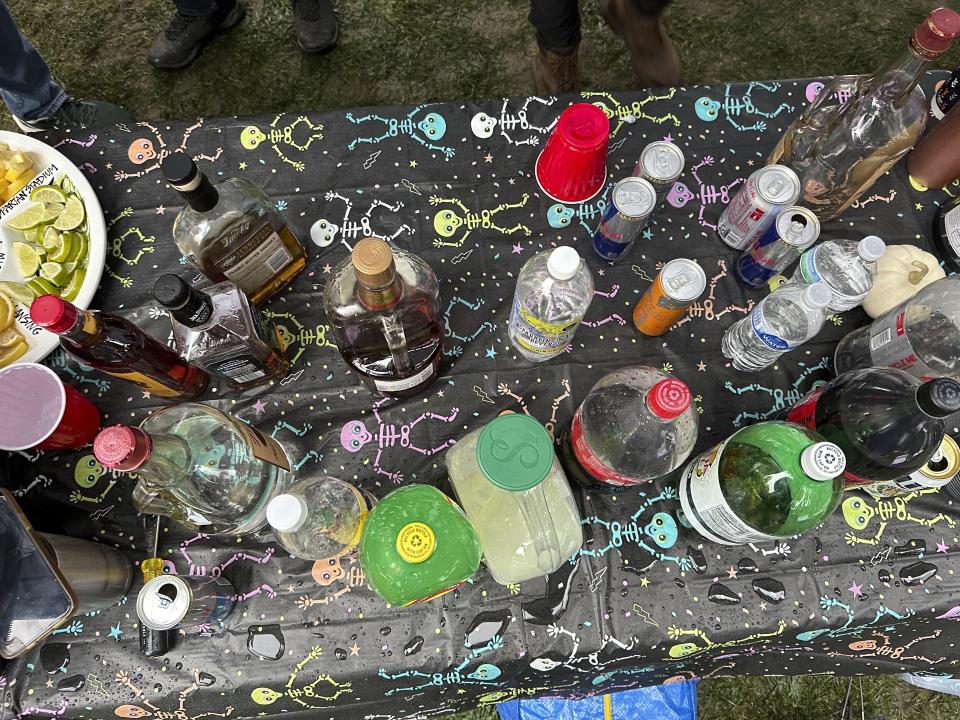 Drinks sits on a table in a tailgating area outside Spartan Stadium before the Michigan-Michigan State NCAA college football game Saturday, Oct. 21, 2023, in East Lansing, Mich. Michigan State University started selling alcoholic beverages at the stadium this fall. According to a survey by The Associated Press of Power Five conference schools and Notre Dame, 55 of 69 of them sell alcohol in the public areas of their stadiums on game days. (AP Photo/Mike Householder)