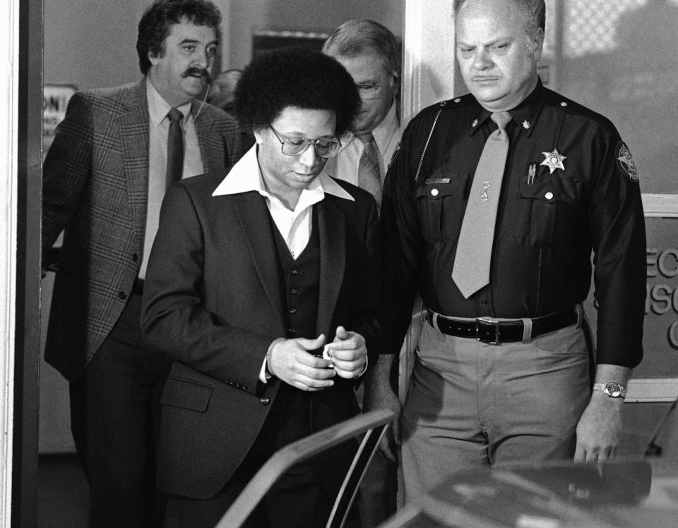 FILE - This Feb. 23, 1982 file photo shows Wayne B. Williams leaving the Fulton County Jail in Atlanta to go to court where he will continue testifying in his trial on charges of killing two black children in Atlanta. Williams was given two life sentences in connection to two of the 29 murders. A new HBO documentary “Atlanta’s Missing and Murder: The Lost Children” will take a deep dive into the case involving a string of murders that terrorized the city’s black community 40 years ago. With Atlanta’s mayor pushing to reopen in the case, the five-part series that airs Sunday will explore if Williams or anyone else was truly behind the killing spree. (AP Photo/Gary Gardiner, File)