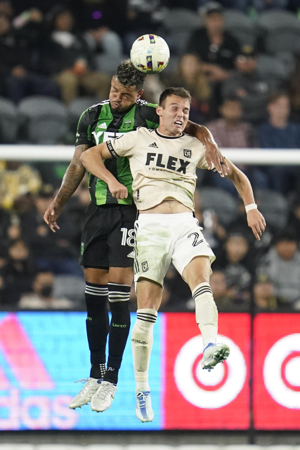 Austin FC defender Julio Cascante (18) and Los Angeles FC defender Franco Escobar (2) head the ball during the first half of an MLS soccer match in Los Angeles, Wednesday, May 18, 2022. (AP Photo/Ashley Landis)