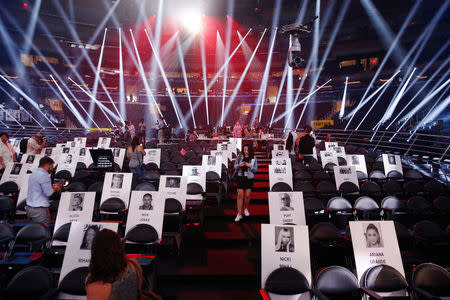 Journalists walk through cardboard cutouts showing where attendees will sit for the upcoming 2016 MTV VMA awards in New York, U.S., August 25, 2016. REUTERS/Lucas Jackson