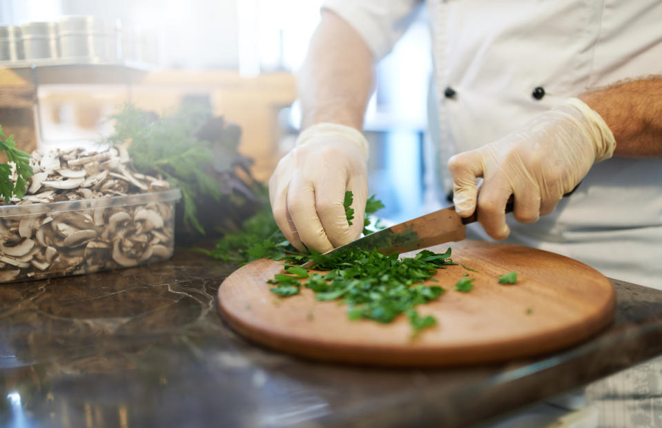 A chef is chopping vegetables