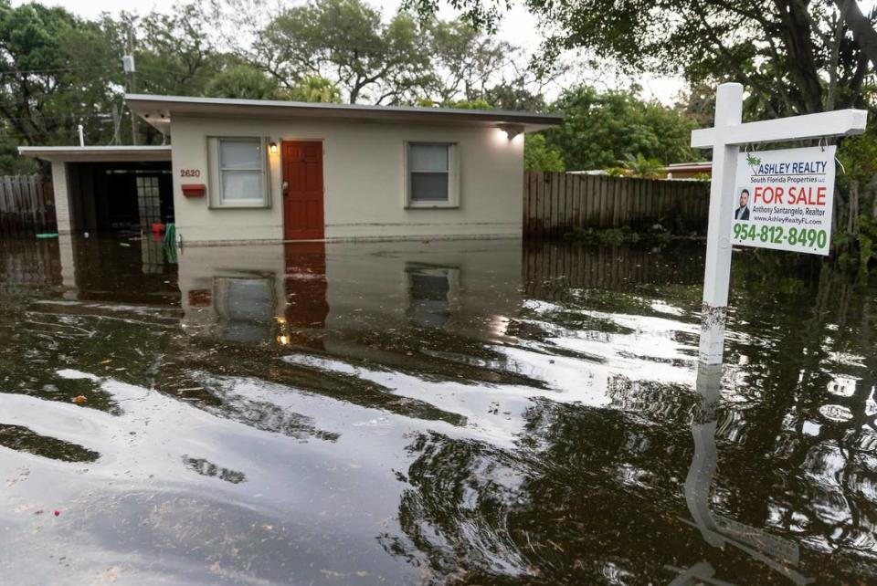 A property that is for sale is seen partially submerged in the Edgewood neighborhood on Thursday, April 13, 2023, in Fort Lauderdale, Fla. Fort Lauderdale was drenched Wednesday with more than 2 feet of rain, what normally occurs in a month.