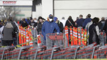 A person wears a mask as he stands in line at Costco Saturday, April 4, 2020, in Salt Lake City. The Centers for Disease Control and Prevention is now advising Americans to voluntarily wear a basic cloth or fabric face mask to help curb the spread of the new coronavirus. (AP Photo/Rick Bowmer)