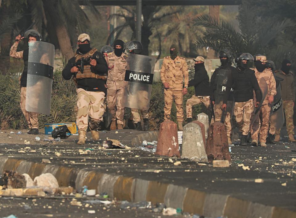 Security forces try to disperse anti-government protesters during clashes in central Baghdad, Iraq, Monday, Jan. 20, 2020. Iraqi security forces also used live rounds, wounding over a dozen protesters, medical and security officials said, in continuing violence as anti-government demonstrators make a push to revive their movement in Baghdad and the southern provinces. (AP Photo/Hadi Mizban)