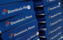 Domino's pizza boxes are pictured inside a restaurant in Noida