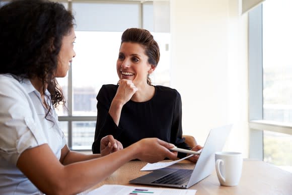 Two professional females at a conference table