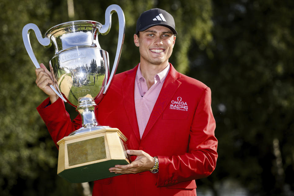 Winner Ludvig Aberg of Sweden poses with the trophy of the European Masters Golf Tournament DP World Tour, in Crans-Montana, Switzerland, Sunday, Sept. 3, 2023. (Jean-Christophe Bott/Keystone via AP)