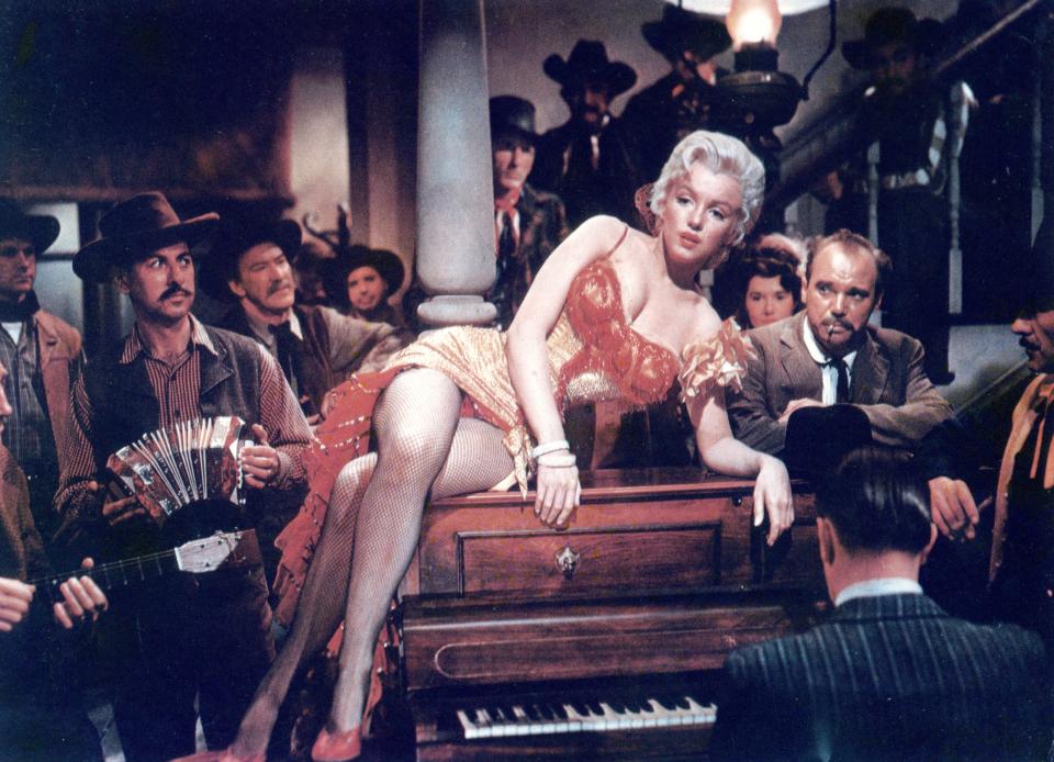 Marilyn Monroe reclining on a piano during &quot;River of No Return&quot; (1950).