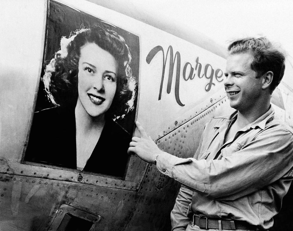 FILE - Captain Richard J. Bong, of Poplar, Wis., points to a large picture of his girl friend, Marge Vattendahl, on his Lighting P-38 fighter plane pilot stationed at a New Guinea Air Base, March 31, 1944. Searchers announced Thursday, May 23, 2024, that they've discovered what they believe is the wreckage of World War II ace Bong's plane in the South Pacific. (AP Photo, File) / Credit: / AP