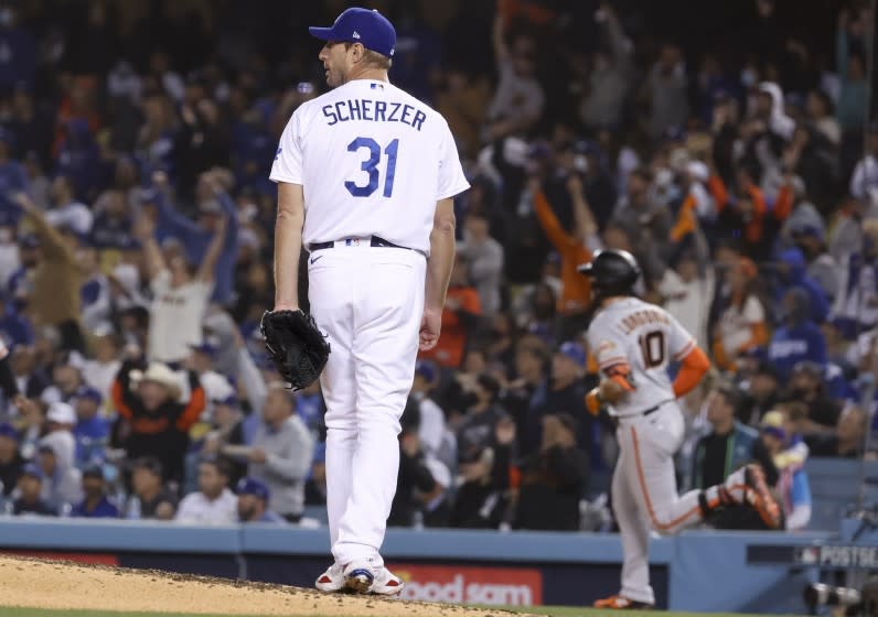 Los Angeles, CA - October 11: Los Angeles Dodgers starting pitcher Max Scherzer, left, looks back.