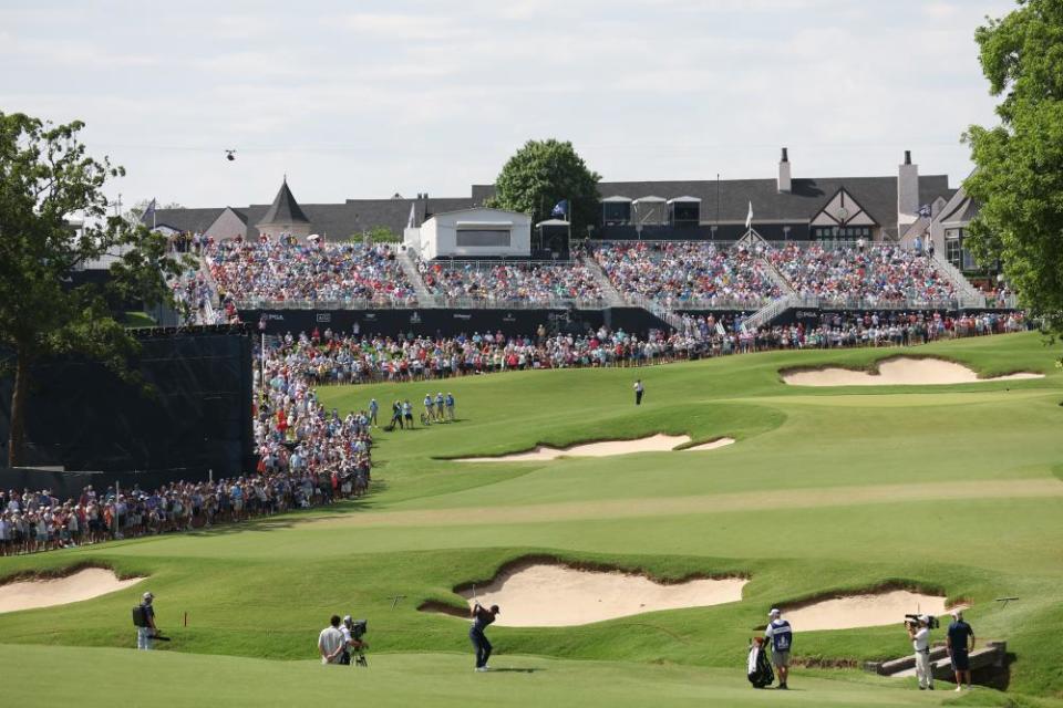 Tiger Woods plays a shot on the 18th hole