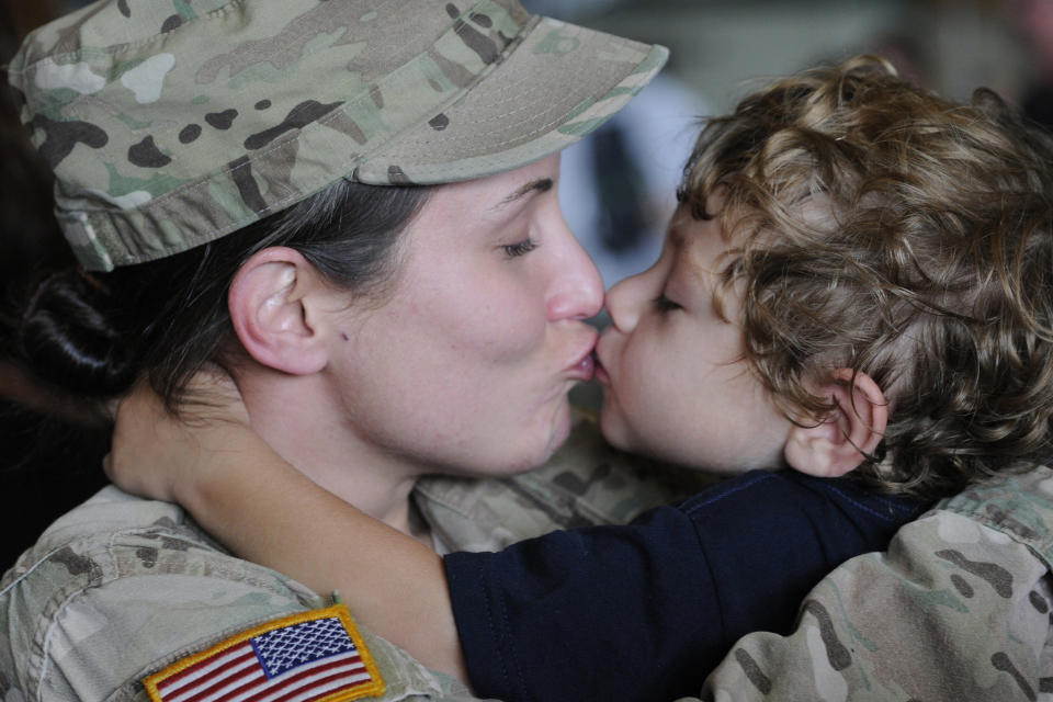 Spc. Sabrina Day, 132nd Military Police Company, South Carolina National Guard, smothers her three-year-old son Blake with hugs and kisses on Aug. 4, 2014, at Eagle Aviation in Columbia, South Carolina, upon returning from deployment to Afghanistan.