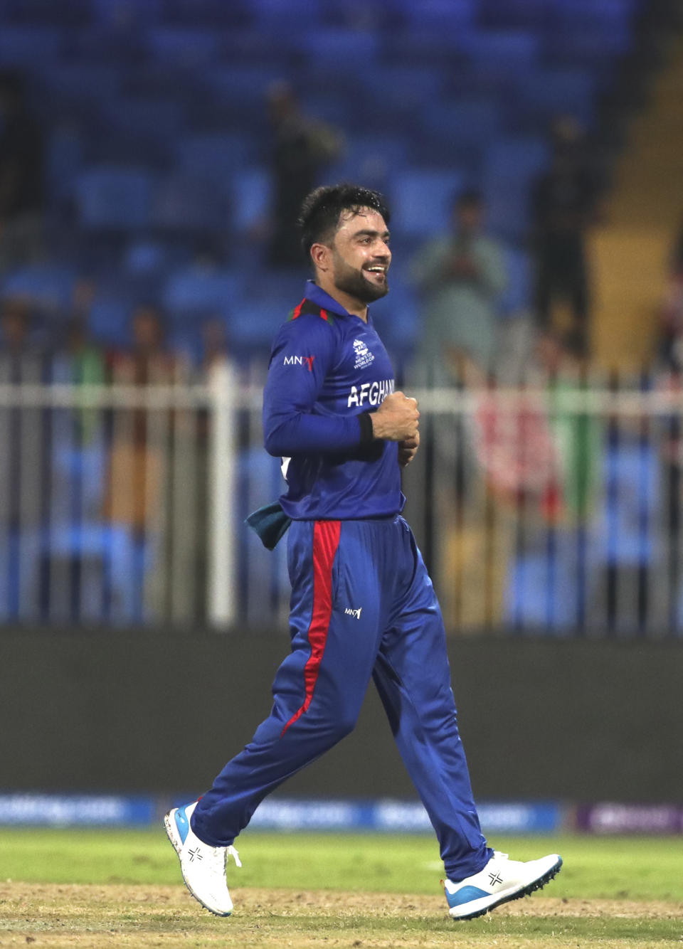 Afghanistan's Rashid Khan celebrates after his team won against Scotland during the Cricket Twenty20 World Cup match in Sharjah, UAE, Monday, Oct. 25, 2021. (AP Photo/Aijaz Rahi)