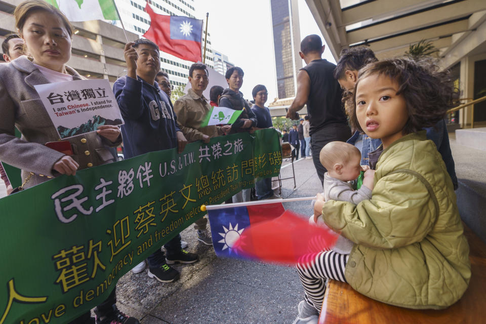 Lucky Hung, 5, joins her parents waiting for Taiwan's President Tsai Ing-wen's arrival outside The Westin Bonaventure Hotel in Los Angeles Tuesday, April 4, 2023. (AP Photo/Damian Dovarganes)