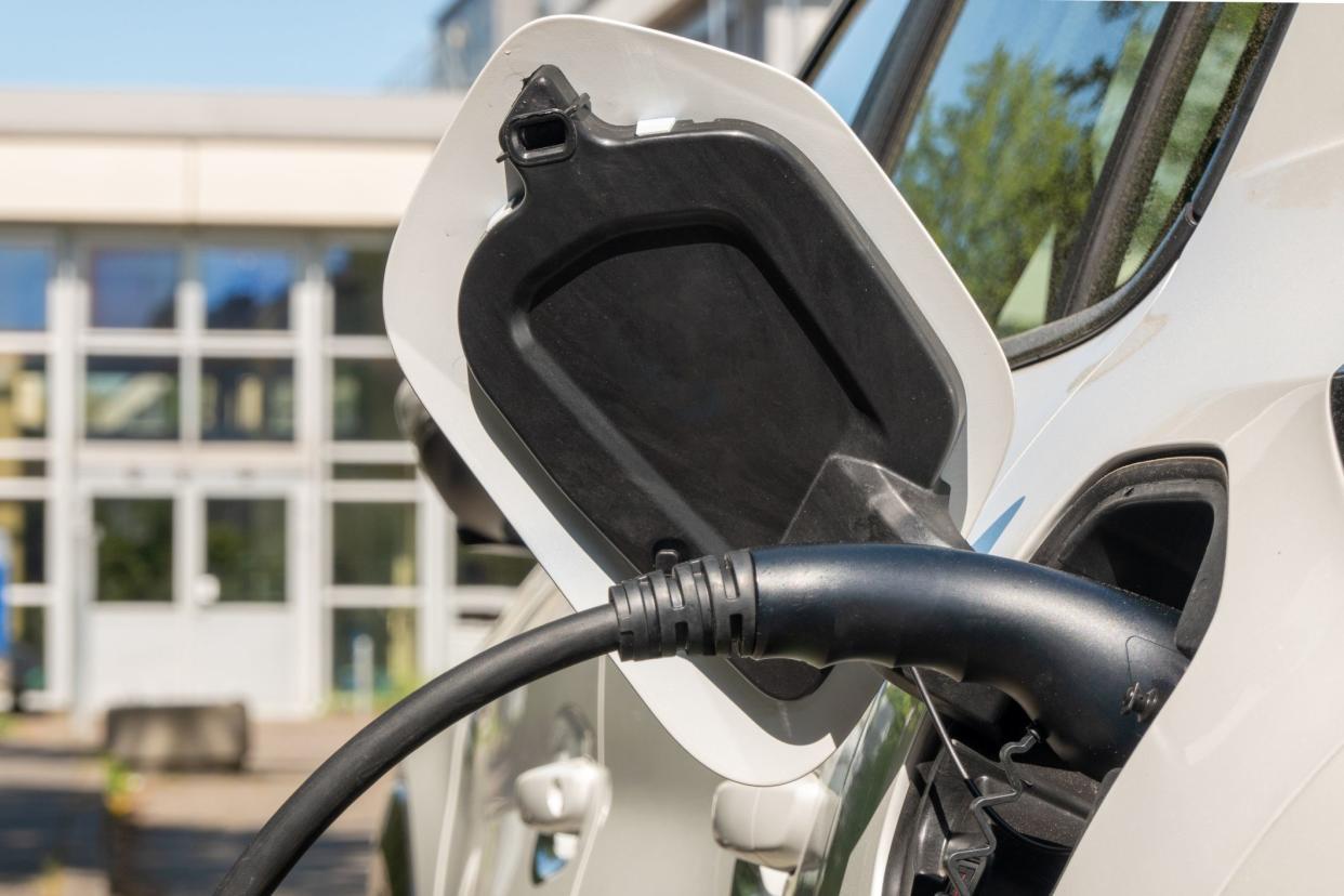 Charging the electric vehicle in front of the company