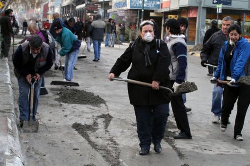 Volunteers sweep ash expelled by the Chilean volcano Puyehue in a street of Bariloche, Argentina. Chile's nearby Puyehue volcano, which June 4 burst into eruption after decades of silence, disrupting air traffic in South America, Australia and New Zealand