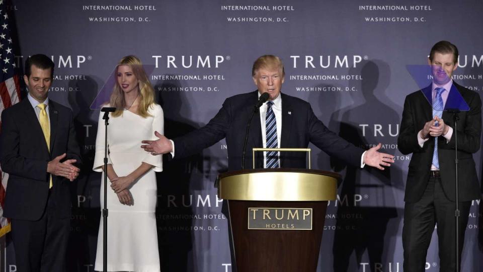 (FILES) In this file photo taken on October 26, 2016, Republican presidential nominee Donald Trump, with children (L-R) Donald Trump Jr., Ivanka Trump, and Eric Trump, during the grand opening of the Trump International Hotel in Washington, DC. - A New York judge on January 13, 2023, fined Donald Trump's family business the maximum penalty available of $1.6 million for committing tax fraud. The Trump Corporation and Trump Payroll Corp., entities of the Trump Organization, were found guilty last month of running a years-long scheme to defraud and evade taxes through falsifying business records. (Photo by MANDEL NGAN / AFP)