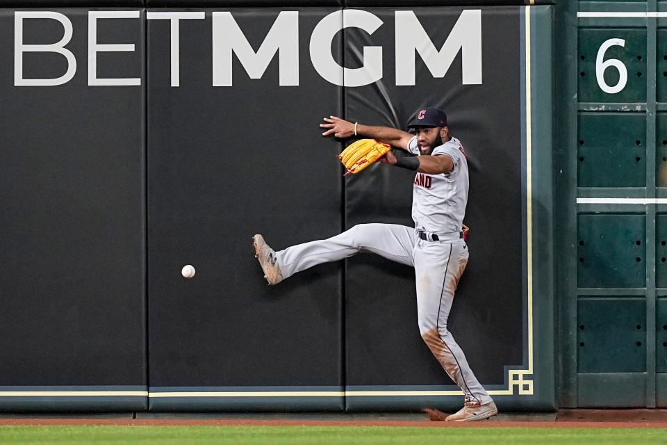 Cleveland Guardians left fielder Amed Rosario tries to catch a double by Houston Astros' Jose Altuve during the sixth inning of a baseball game Monday, May 23, 2022, in Houston. (AP Photo/David J. Phillip)