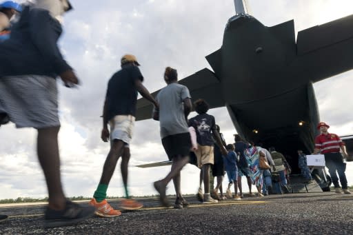 Residents of McArthur River, a remote town in the Northern Territory, boarding an Australian military plane as authorities evacuate communities in the path of a powerful cyclone