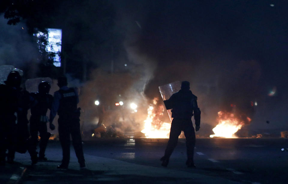 Riot police take to the streets, during a night of rioting in Tegucigalpa, Honduras, late Thursday, June 20, 2019. Protesters blockaded highways, clashed with police as part of demonstrations against President Juan Orlando Hernández. (AP Photo/Elmer Martinez)