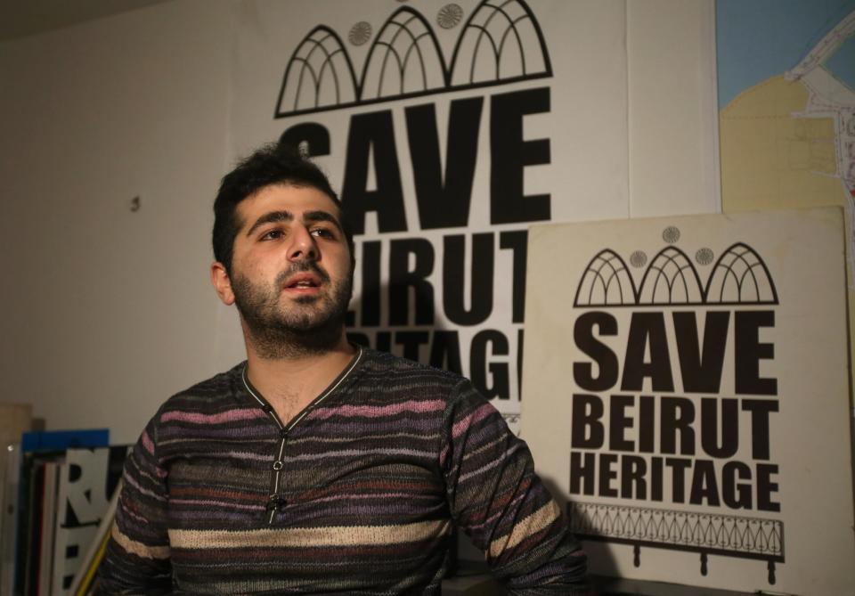 In this April 8, 2014 photo, Naji Raji, an activist and spokesman for Save Beirut Heritage, speaks during an interview with The Associated Press, in Beirut, Lebanon. An initial census in the early 1990s counted 1600 traditional homes and buildings in the greater Beirut area, while today, an estimated 250 standing structures remain, said Raji. Save Beirut Heritage has a hotline through which it receives tips about old buildings threatened with demolitions, which it conveys to the Culture Ministry. This has allowed the group to halt the demolition of up to 60 buildings in Beirut and its suburbs since 2010. (AP Photo/Hussein Malla)