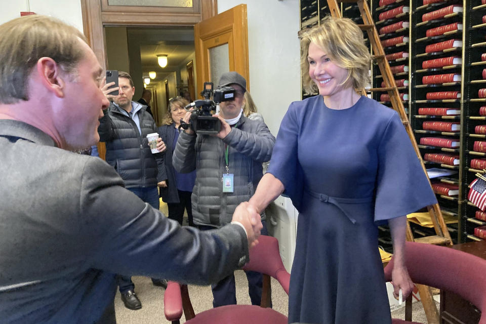 Kelly Craft, right, greets Kentucky Secretary of State Michael Adams on Thursday, Jan. 5 , 2023, in Frankfort, Ky., as she files to run for governor of Kentucky. Craft is competing in a crowded GOP primary as Republicans try to unseat Democratic Gov. Andy Beshear in this year's election. (AP Photo/Bruce Schreiner)