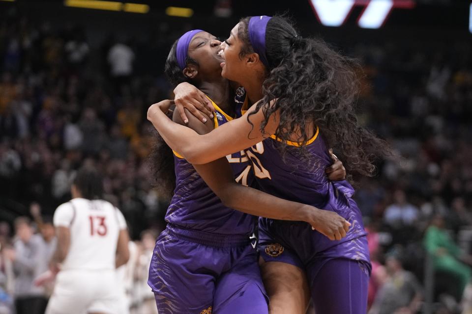 LSU's Flau'jae Johnson and Angel Reese celebrate after an NCAA Women's Final Four semifinals basketball game against Virginia Tech Friday, March 31, 2023, in Dallas. LSU won 79-72 to advance to the championship game on Sunday. (AP Photo/Darron Cummings)