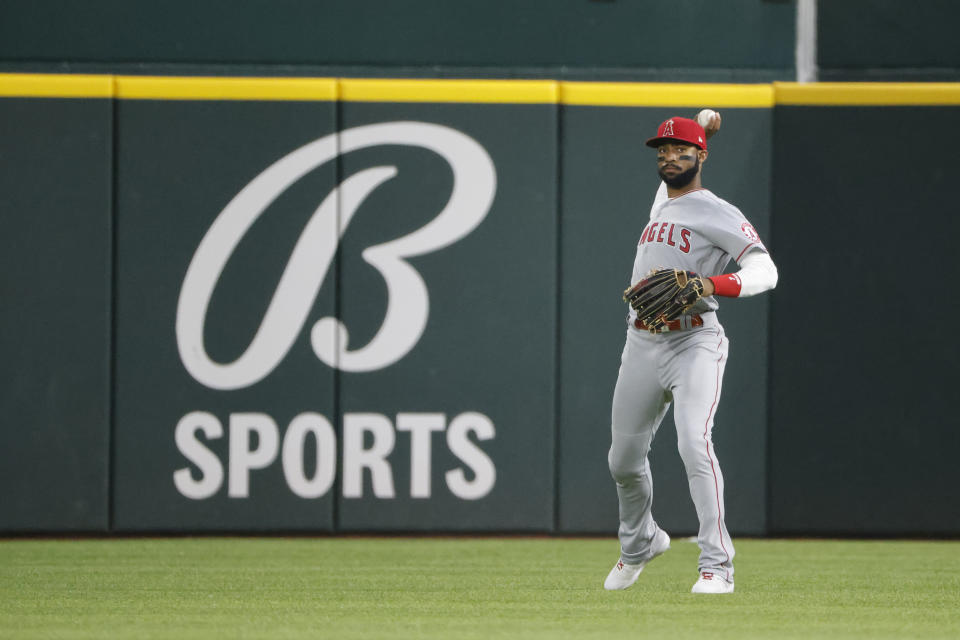 Los Angeles Angels right fielder Jo Adell throw the ball back into the infield after making a catch against the Texas Rangers during the third inning of a baseball game, Friday, April 15, 2022, in Arlington, Texas. (AP Photo/Michael Ainsworth)