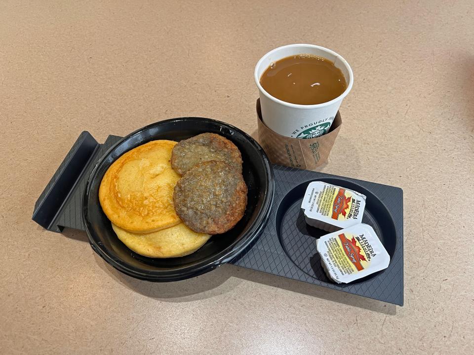 The breakfast the author was served aboard the Amtrak dining car, including pancakes, sausage, and coffee.