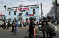 Police walk past the Apra party headquarters where Peru's former President Alan Garcia's wake is taking place after he fatally shot himself on Wednesday, in Lima, Peru April 18, 2019. REUTERS/Guadalupe Pardo