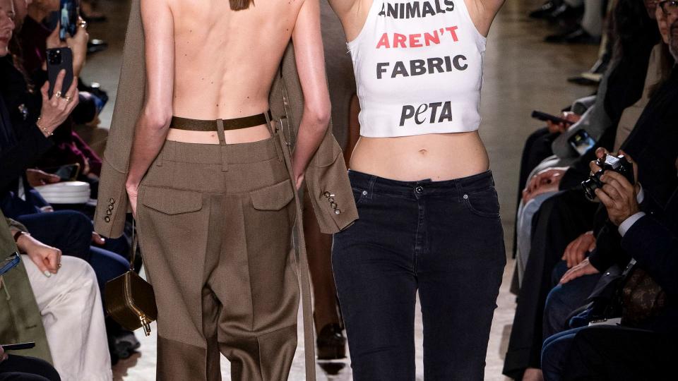 Protestors appear on the runway during the Victoria Beckham Ready to Wear Fall/Winter 2024-2025 fashion show as part of the Paris Fashion Week 