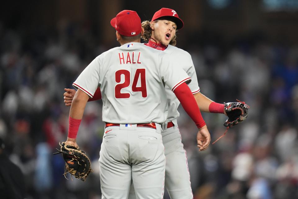 Philadelphia Phillies' Alec Bohm, right, celebrates with Darick Hall (24) after a baseball game against the New York Yankees Tuesday, April 4, 2023, in New York. The Phillies won 4-1. (AP Photo/Frank Franklin II)