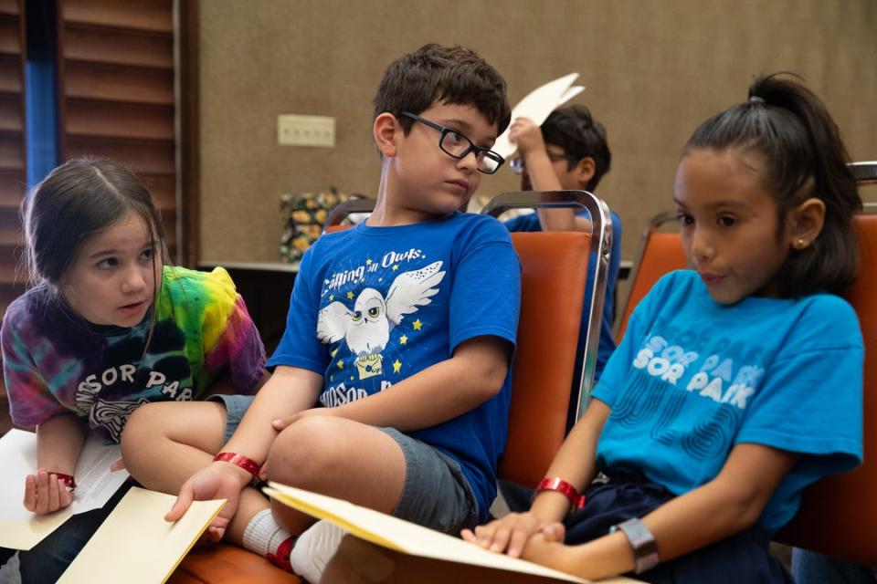 Windsor Park third grade students from left, Logan Pulich, Liam Miller and Mae West, take a seat and speak after giving presentations on the pros and cons of community gardens on Tuesday, Oct. 24, 2023, in Corpus Christi, Texas.