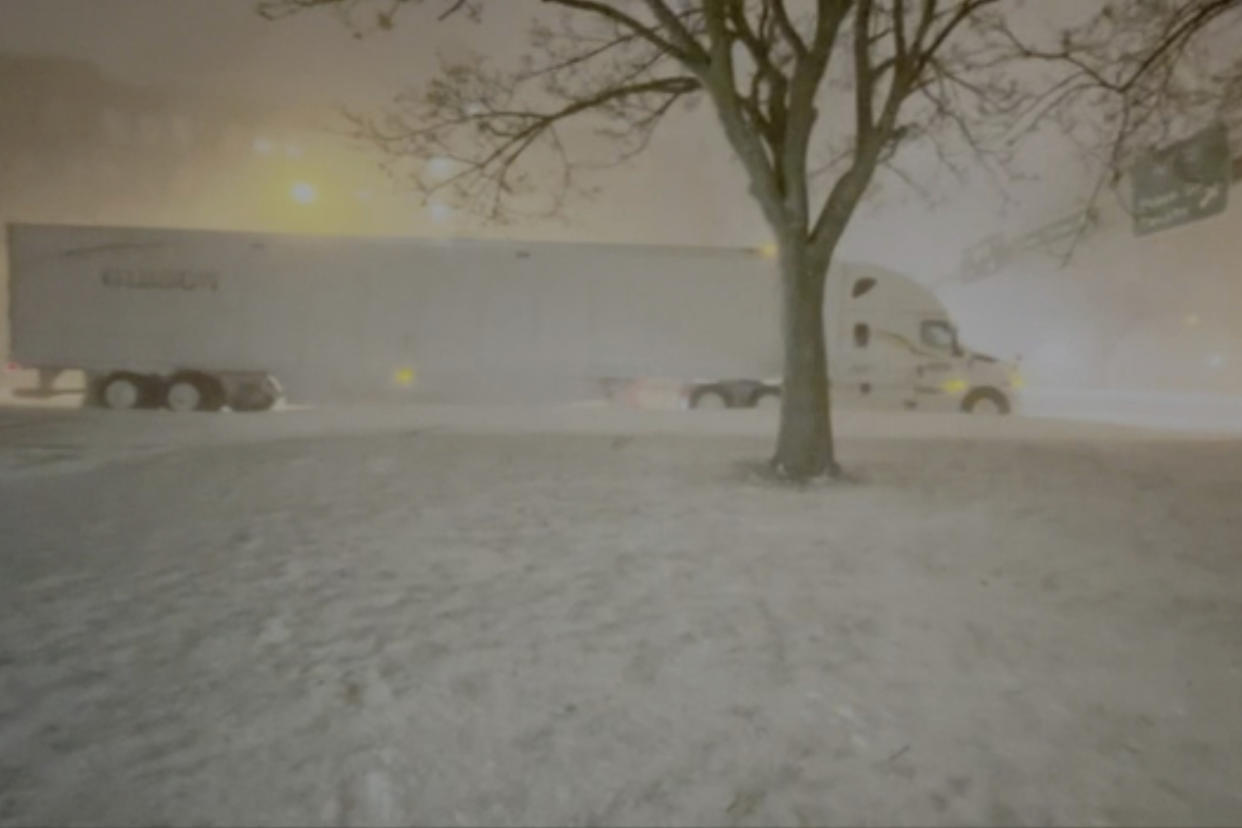 High winds and snow covers the streets and vehicles in Buffalo, N.Y. early Sunday, Dec. 25, 2022. Millions of people hunkered down in a deep freeze overnight and early morning to ride out the frigid storm that has killed at least 20 people across the United States, trapping some residents inside homes with heaping snow drifts and knocking out power to several hundred thousand homes and businesses.(WKBW via AP)