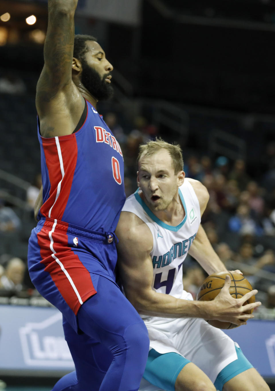 Charlotte Hornets' Cody Zeller (40) tries to get around Detroit Pistons' Andre Drummond (0) during the first half of an NBA preseason basketball game in Charlotte, N.C., Wednesday, Oct. 16, 2019. (AP Photo/Bob Leverone)