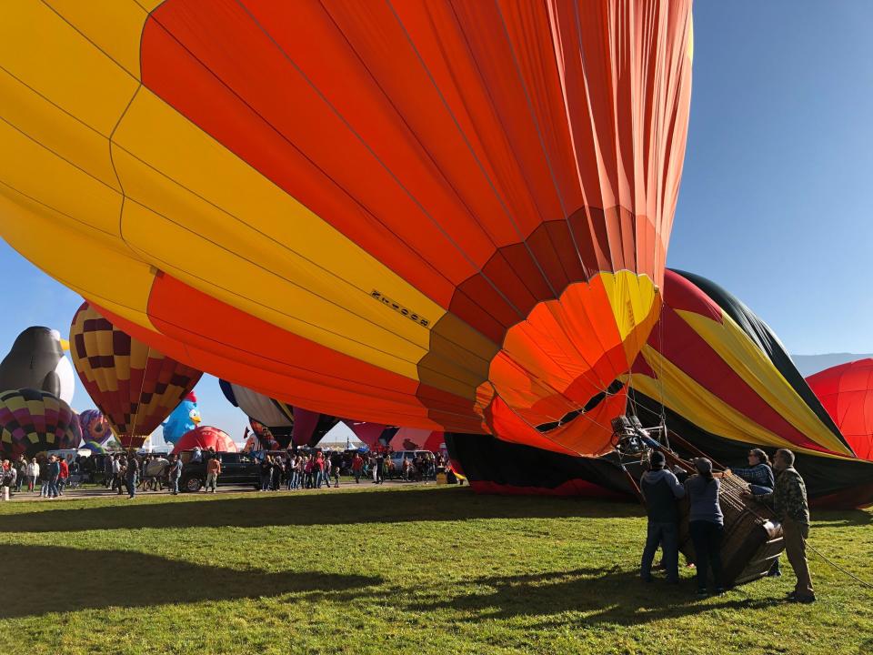 Hot air balloons are inflated during the annual Albuquerque International Balloon Fiesta in Albuquerque, N.M., on Saturday, Oct. 5, 2019. Organizers are expecting tens of thousands of spectators for opening weekend and exponentially more over the course of the nine-day event. (AP Photo/Susan Montoya Bryan)