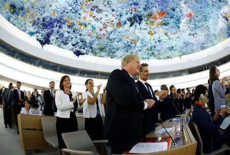 Britain's Foreign Secretary Boris Johnson applauds after the speech of Zeid Ra'ad al-Hussein, outgoing United Nations High Commissioner for Human Rights during the Human Rights Council at the United Nations in Geneva, Switzerland June 18, 2018. Picture taken with a fisheye lens. REUTERS/Denis Balibouse