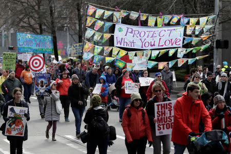 People take part in a "March For Our Lives" demonstration demanding gun control in Seattle, Washington, U.S. March 24, 2018. REUTERS/Jason Redmond