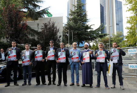 Demonstrators hold pictures of Saudi journalist Jamal Khashoggi during a protest in front of Saudi Arabia's consulate in Istanbul, Turkey, October 5, 2018. REUTERS/Osman Orsal