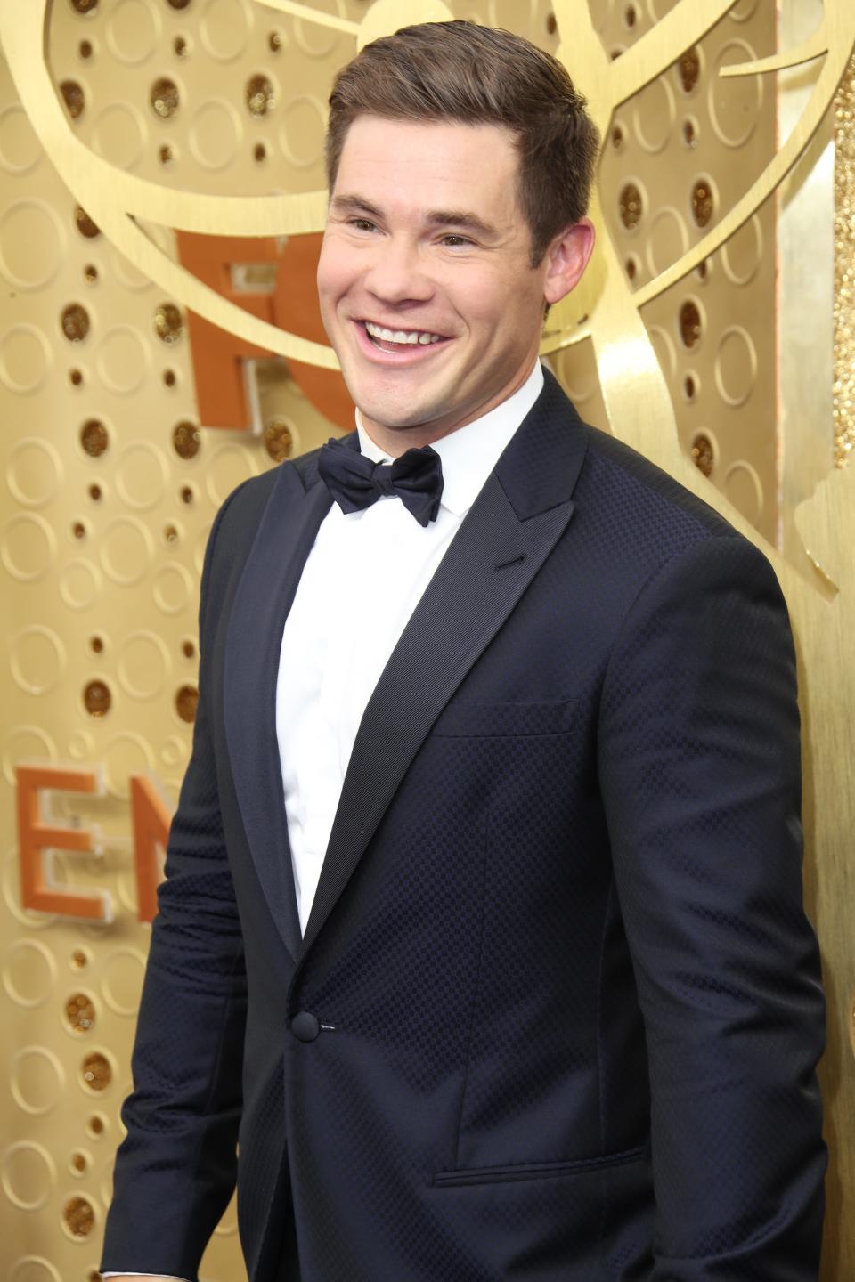 Adam Devine arrives at the Emmy Awards on Sept. 22, 2019.