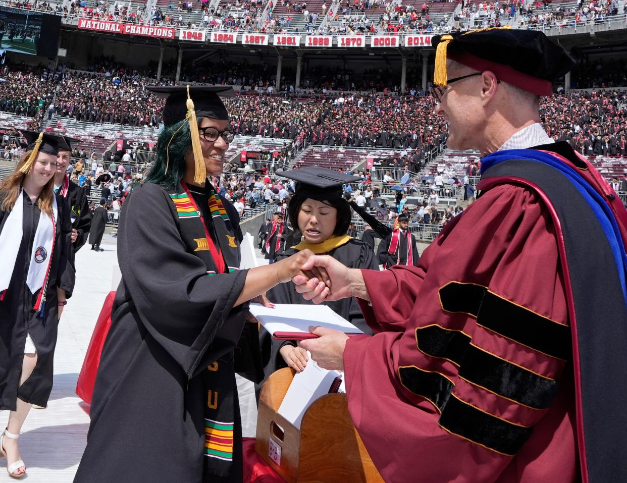May 7, 2023; Columbus, Ohio, United States; Nikia Gales shakes hands with David A. Jenkins, PhD, LCSW, the dean of The Ohio State University College of Social Work during spring commencement. Mandatory Credit: Barbara Perenic/The Columbus Dispatch