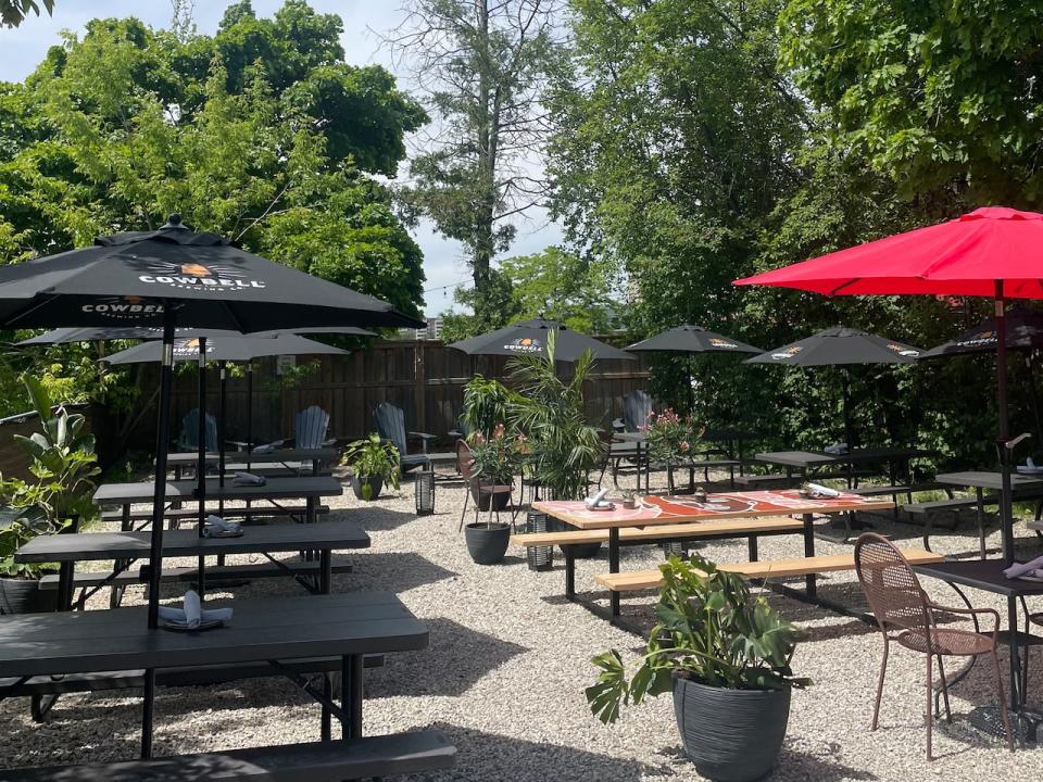 Red House's backyard patio in uptown Waterloo is surrounded by trees and tropicals.