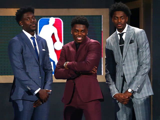 Mike Stobe/Getty Aaron Holiday poses with brothers Justin Holiday and Jrue Holiday during the 2018 NBA Draft.