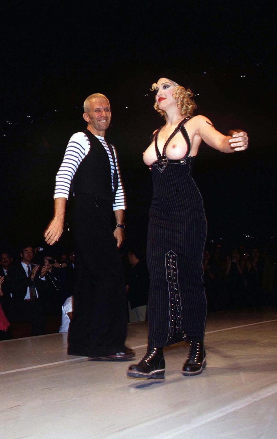 <p>Madonna’s relationship with Jean Paul Gaultier has always been strong. He designed her early tour wardrobes and that infamous cone bra. In return, she walked in his 1992 LA show wearing nothing but braced trousers and a beret. <i>[Photo: Rex]</i> </p>