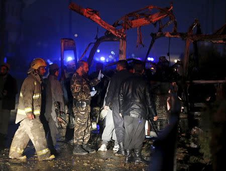 Afghan policemen and fire-fighters inspect the wreckage of a bus that was hit by a suicide bomb attack, in an area near the Russian embassy in Kabul, Afghanistan January 20, 2016. REUTERS/Omar Sobhani