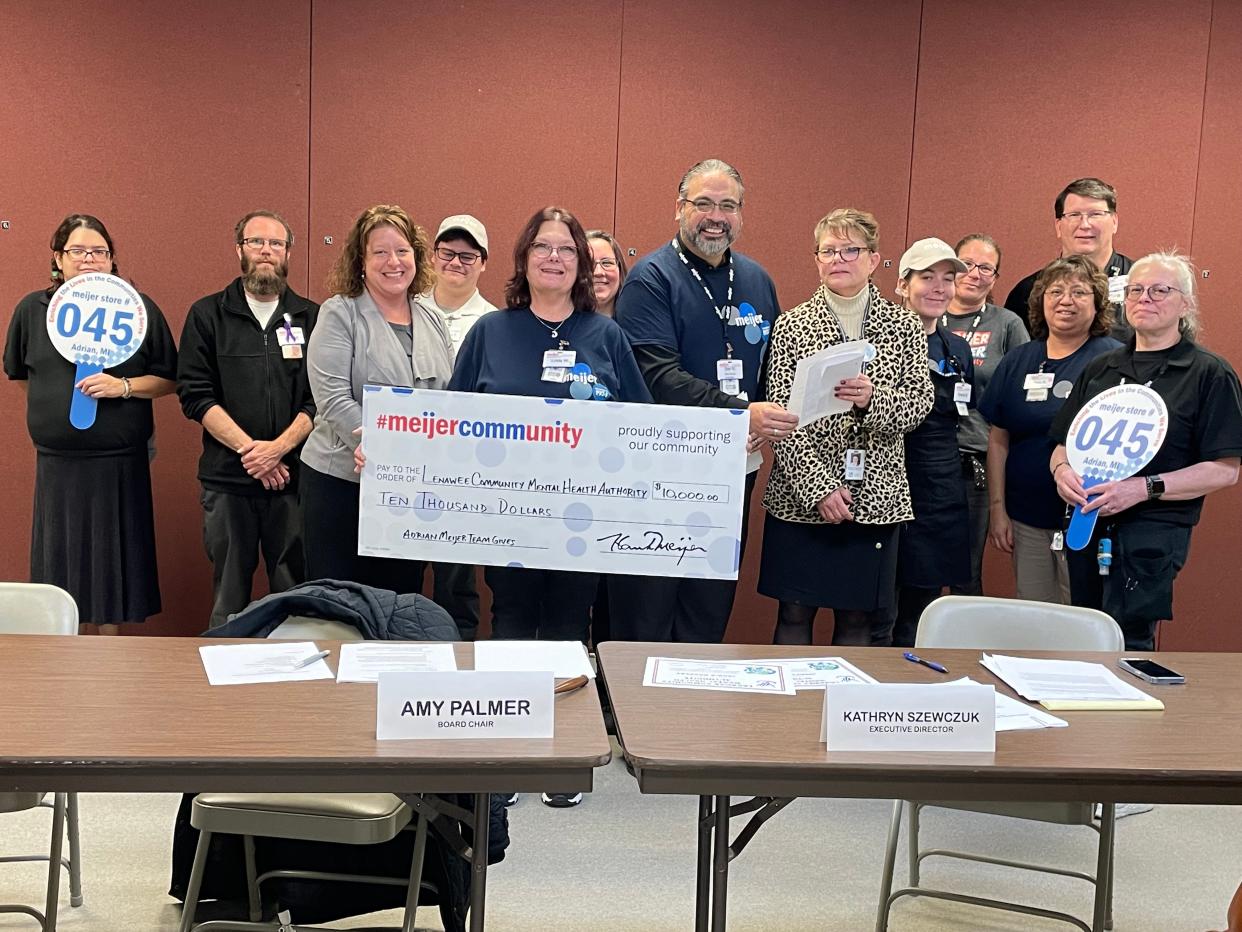 Adrian Meijer employees deliver a check for $10,000 to the Lenawee Community Mental Health Authority on Nov. 30.