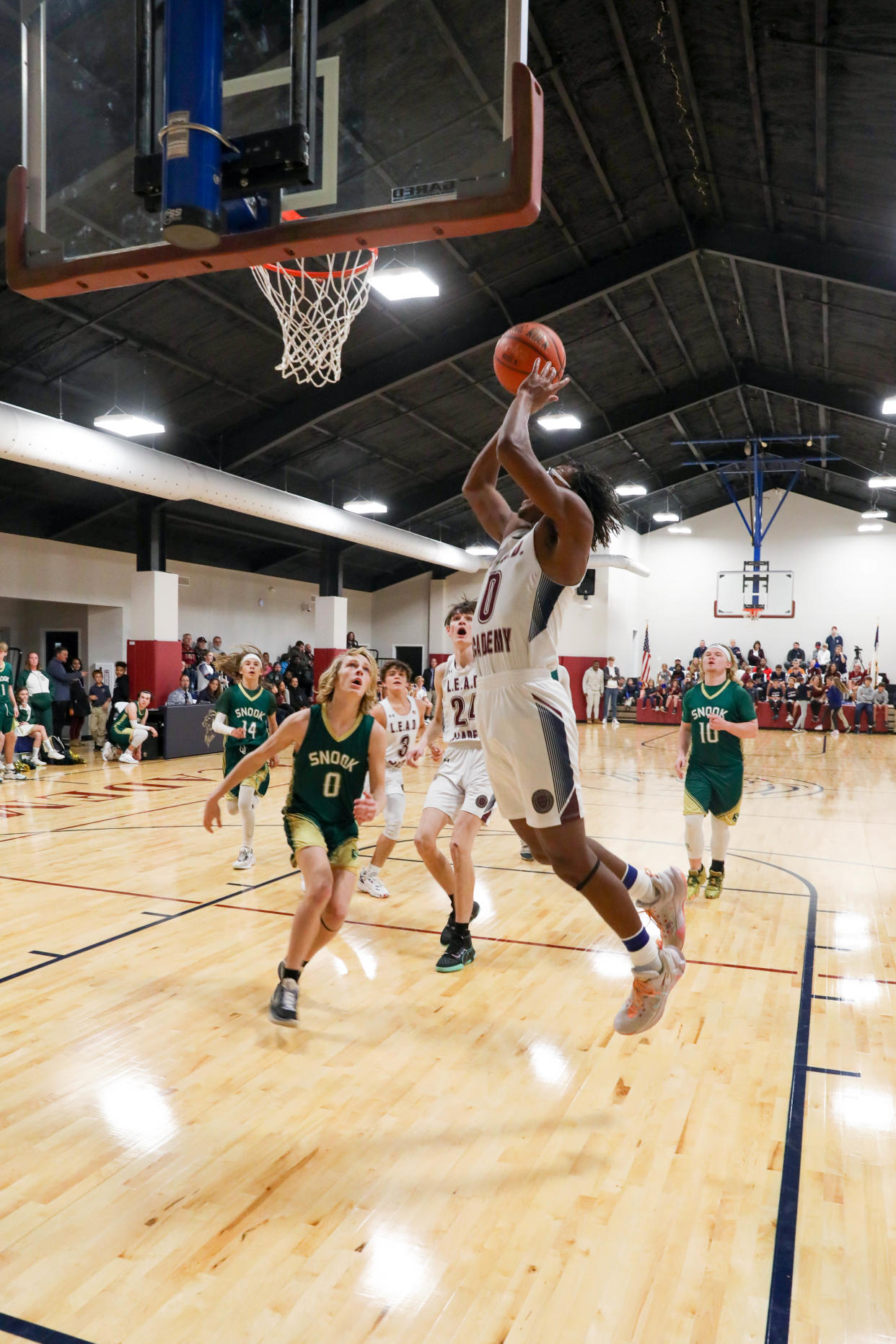 L.E.A.D.'s Ezekal Crumpton finishes a layup versus Snook Christian Academy on his birthday.