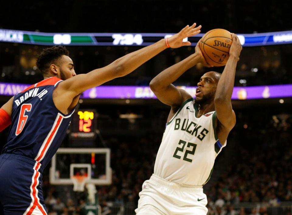 Bucks forward Khris Middleton puts up a shot over Washington's Troy Brown Jr. Middleton scored 51 points Tuesday night.