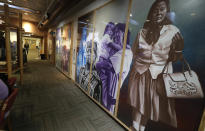 Artwork fills a wall in a waiting room at a clinic offering health care and other services operated by the Seattle Indian Health Board, Friday, Jan. 11, 2019, in Seattle. Fallout from the federal government shutdown is hurting hundreds of Native American tribes and entities that serve them. The pain is especially deep in tribal communities with high rates of poverty and unemployment, and where one person often supports an extended family. (AP Photo/Ted S. Warren)